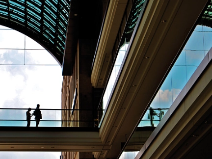 two people standing under an arch of building
